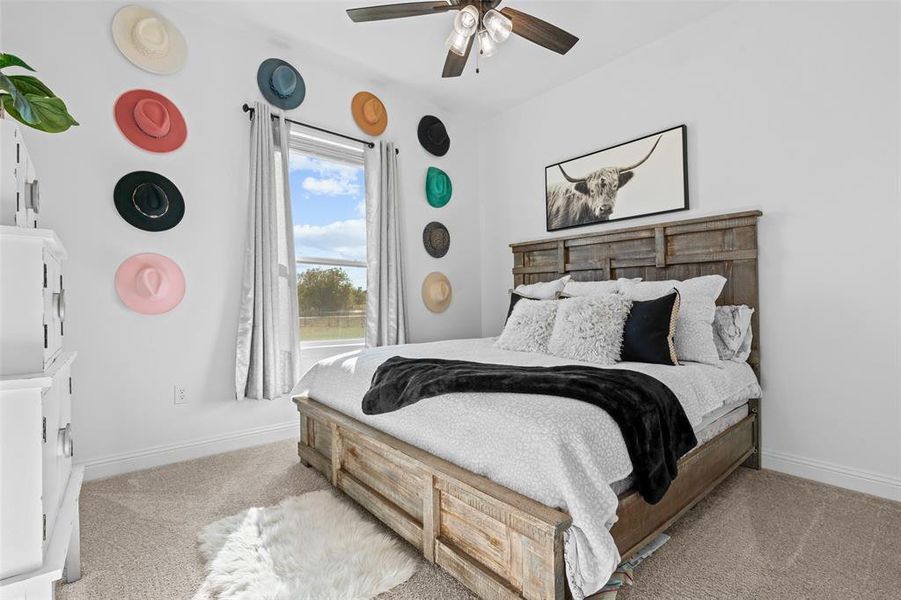 Carpeted bedroom with ceiling fan