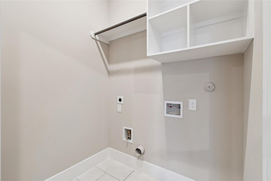 Functional but never forgotten—this laundry room integrates storage, utility, and architectural ease.