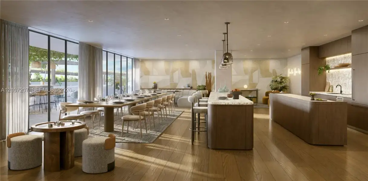 Open-concept space featuring floor-to-ceiling windows, wood-finish flooring, two expansive kitchen islands with stone countertops, and recessed lighting Open-concept space featuring floor-to-ceiling windows, wood-finish flooring, two expansive kitchen islands with stone countertops, and recessed lighting