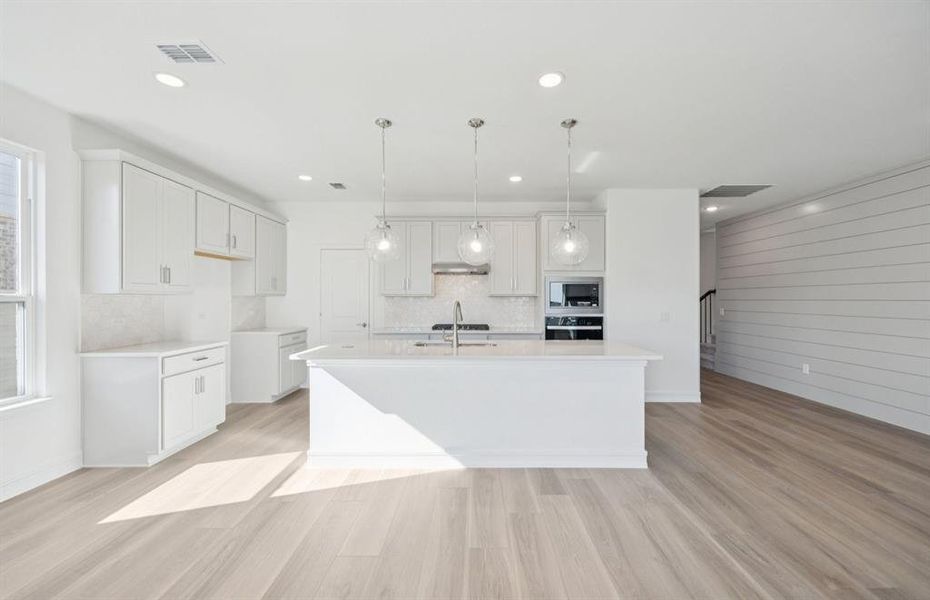 Open island kitchen with accent wall