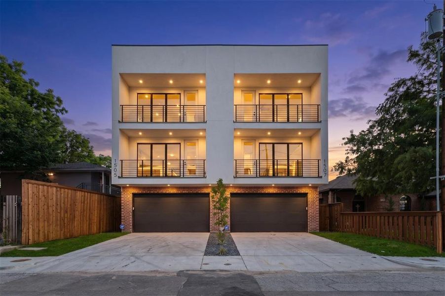 Modern multi-level facade featuring two units, each with two private balconies with metal railings Modern multi-level facade featuring two units, each with two private balconies with metal railings