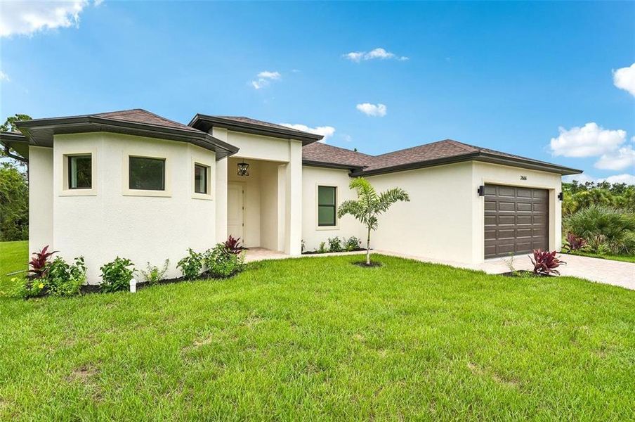 Front exterior of a new home in , North Port, FL, highlighting curb appeal (Image 21). Front exterior of a new home in , North Port, FL, highlighting curb appeal (Image 21).