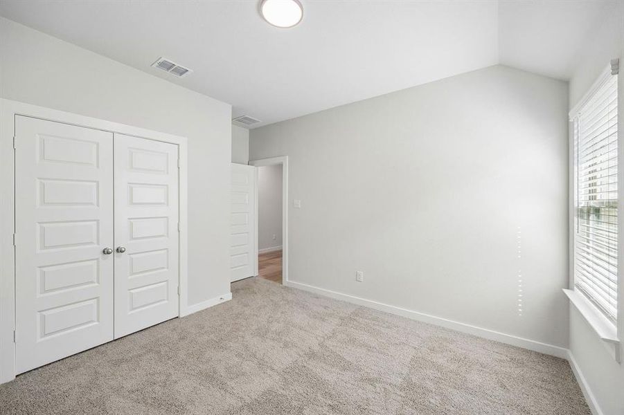 Bedroom in the Oscar home plan by Trophy Signature Homes – REPRESENTATIVE PHOTO