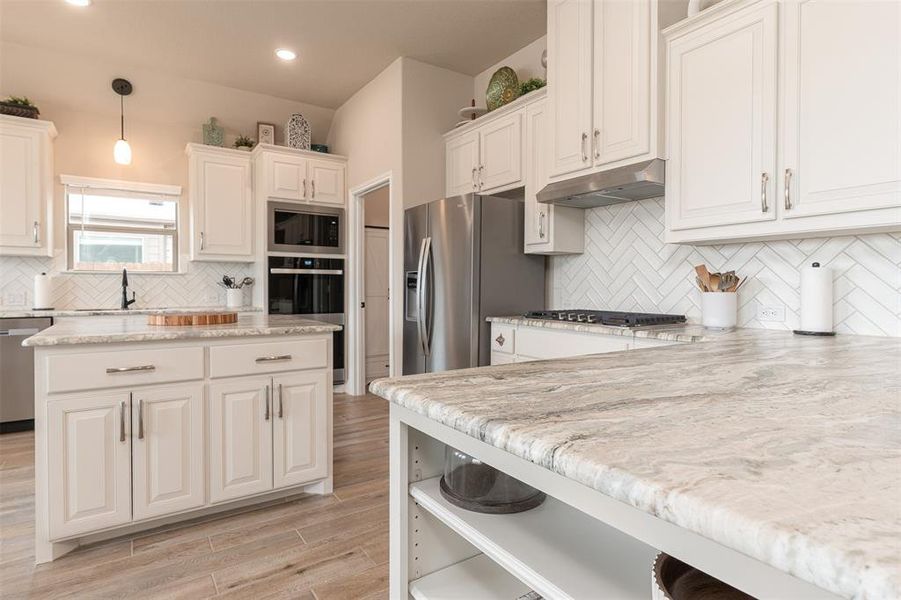 Kitchen white cabinets with "leather upgraded level" granite countertops