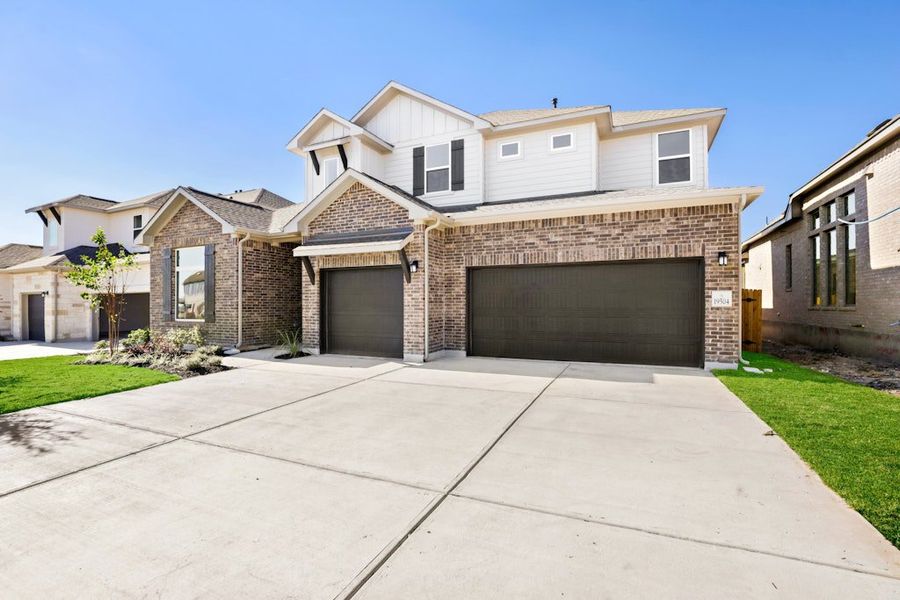 Front exterior of a new home in Blackhawk, Pflugerville, TX, highlighting curb appeal (Image 27).