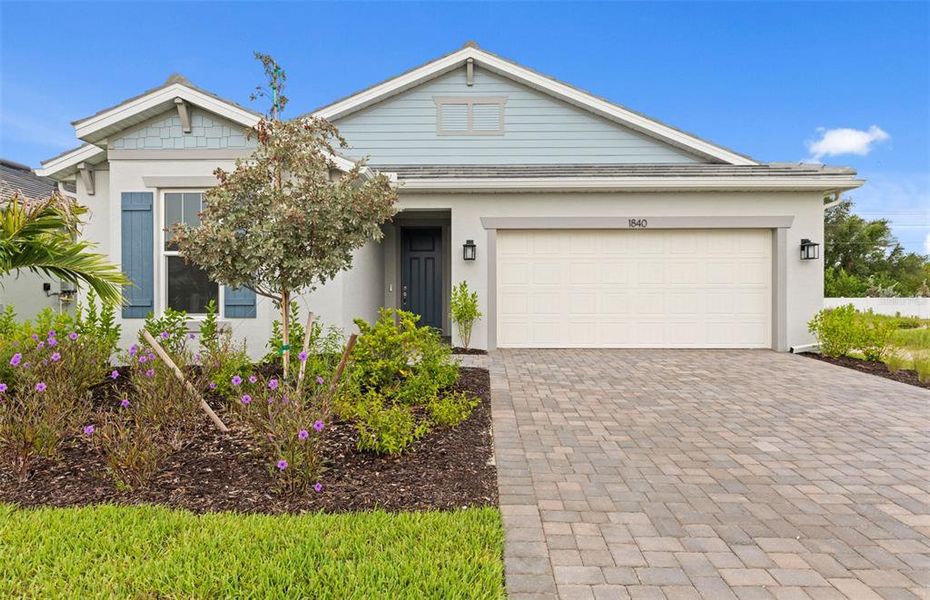 Front exterior of a new home in Shores at Stillwater, Englewood, FL, highlighting curb appeal (Image 23).