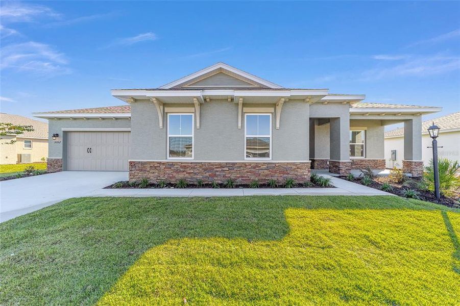 Front exterior of a new home in On Top of the World Communities, Ocala, FL, highlighting curb appeal (Image 24).