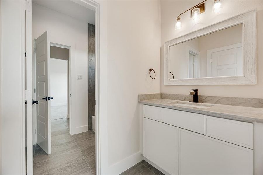 Bathroom featuring vanity and baseboards Bathroom featuring vanity and baseboards