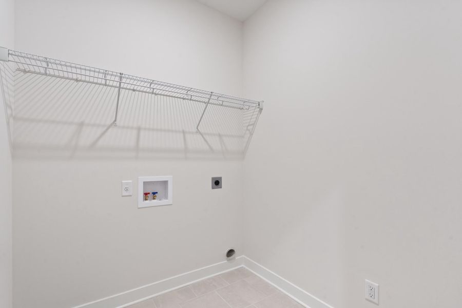 Wire shelving system, wall-mounted utility box, floor-mounted utility outlet, and neutral-toned floor tile