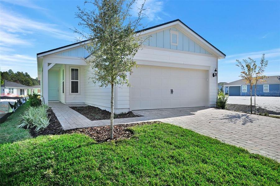 Front exterior of a new home in Seminole Palms, Palm Coast, FL, highlighting curb appeal (Image 2). Front exterior of a new home in Seminole Palms, Palm Coast, FL, highlighting curb appeal (Image 2).