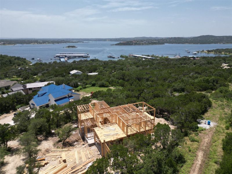 Framed new construction with commanding views of the serene lake and verdant landscape.