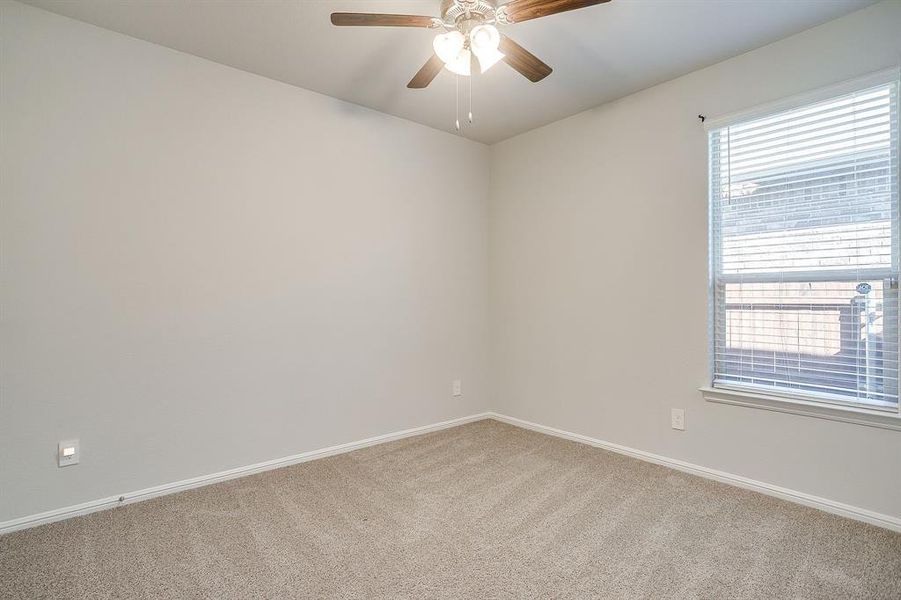 Unfurnished room with light colored carpet and ceiling fan
