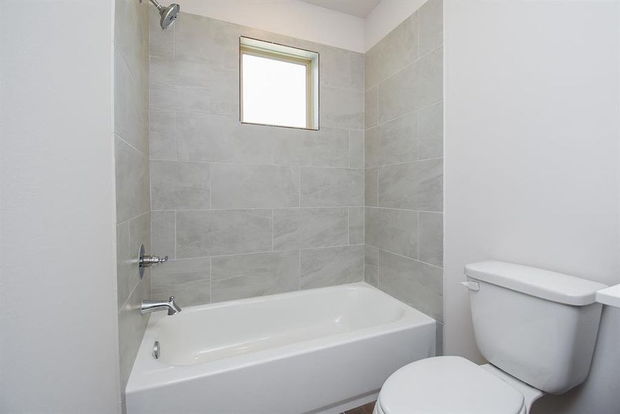 The shower/tub combination has a beautiful and easy-to-maintain tile walls in the shower. The shower/tub combination has a beautiful and easy-to-maintain tile walls in the shower.