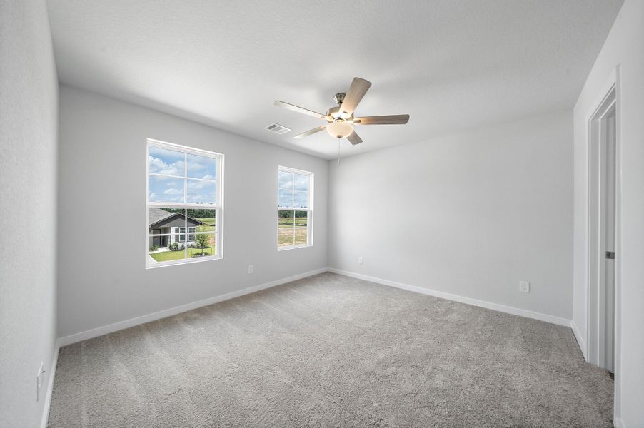 A room with a ceiling fan and a window.