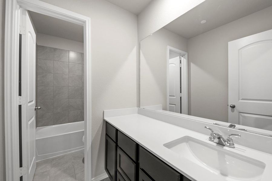 Secondary bath; This stunning new construction boasts sleek lines and a modern aesthetic, blending style with functionality in the most delightful way. Secondary bath; This stunning new construction boasts sleek lines and a modern aesthetic, blending style with functionality in the most delightful way.