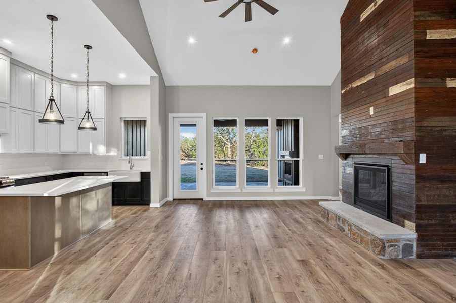 Gorgeous fireplace, luxury vinyl plank flooring, and wooded private views all stand out in this living area!