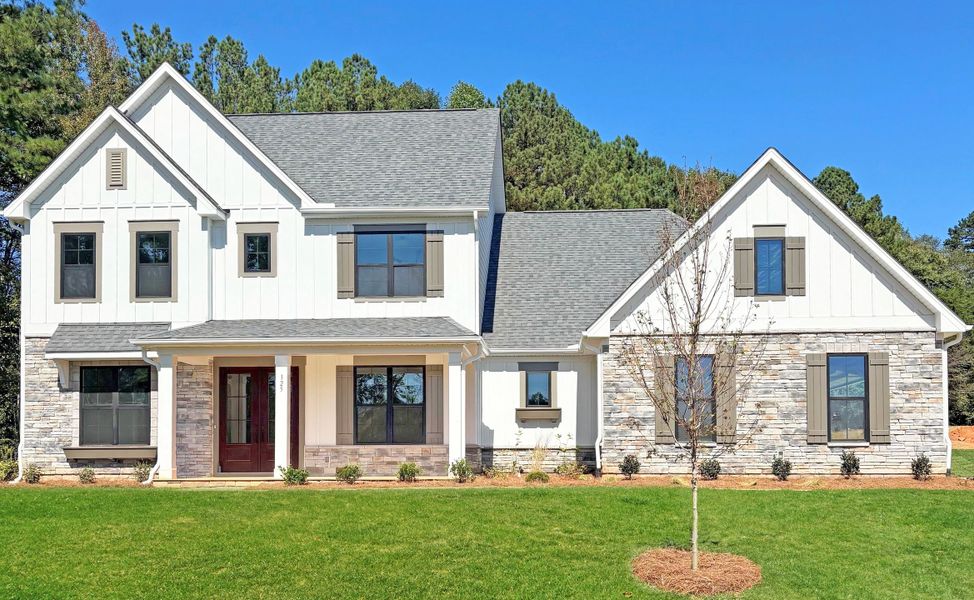 Front exterior of a new home in Saddlehorn, Troutman, NC, highlighting curb appeal (Image 1). Front exterior of a new home in Saddlehorn, Troutman, NC, highlighting curb appeal (Image 1).