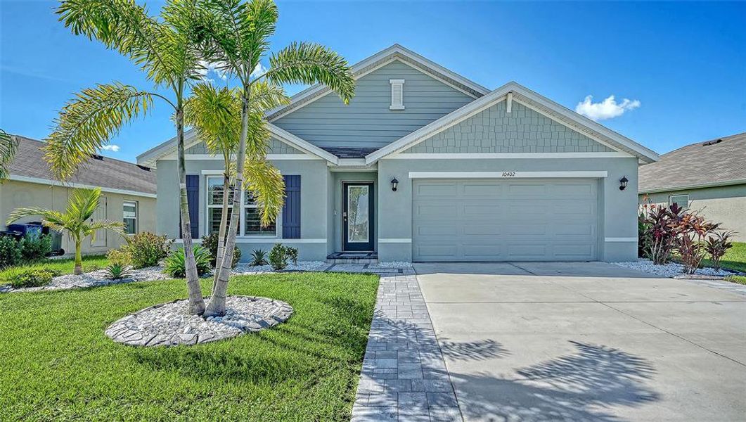 Front exterior of a new home in Bella Lago, Parrish, FL, highlighting curb appeal (Image 27). Front exterior of a new home in Bella Lago, Parrish, FL, highlighting curb appeal (Image 27).