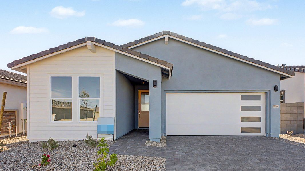 Front exterior of a new home in Teravalis, Buckeye, AZ, highlighting curb appeal (Image 2). Front exterior of a new home in Teravalis, Buckeye, AZ, highlighting curb appeal (Image 2).