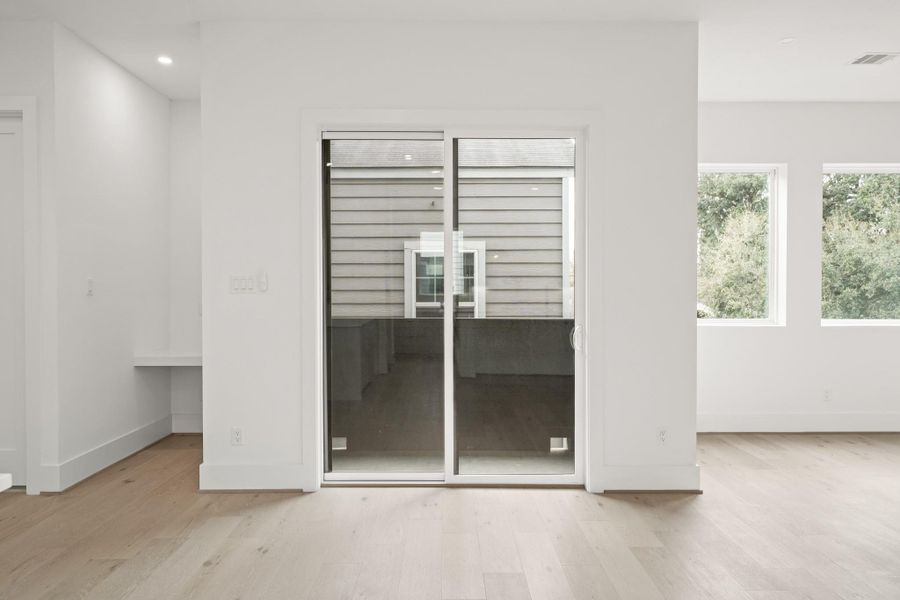 This open floor plan with neutral paint lends itself to a variety of decorating options. The sliding door leads to the covered balcony and a study nook sits nearby.