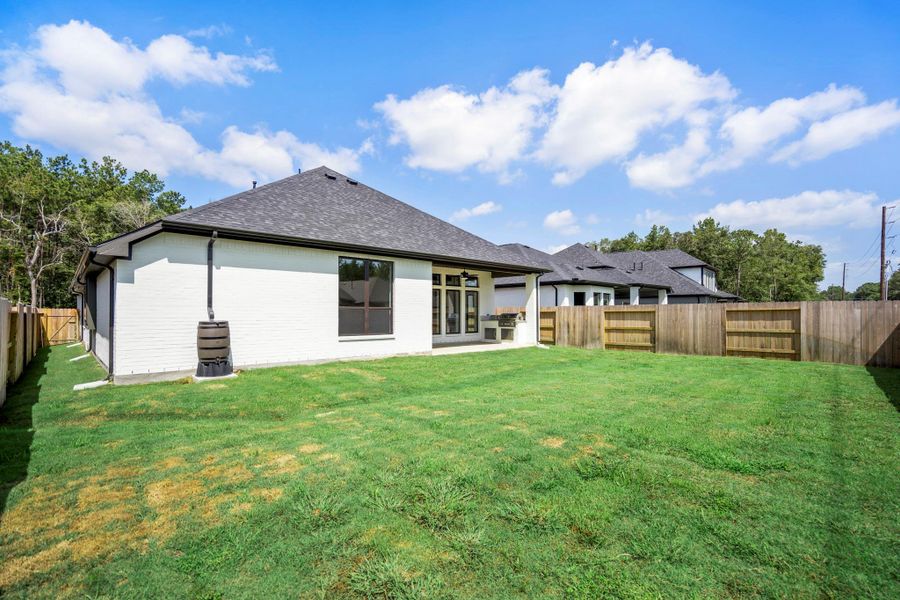 Exterior details and patio area of a home in ARTAVIA, Conroe (Image 26).