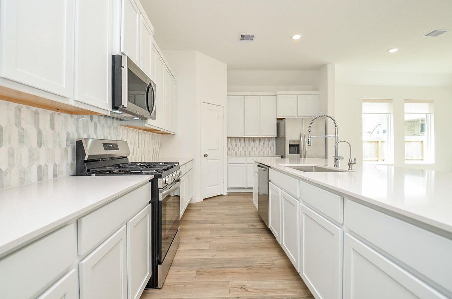 Tons of countertops space for meal prep and plenty of cabinets/drawers. Coffee bar area to the left of the refrigerator