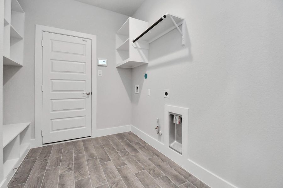 A perfect blend of functionality and comfort. Capture the essence of easy living with a first-floor laundry room, thoughtfully equipped with shelving for effortless organization. Both electric and gas connections available.