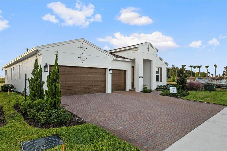 Front exterior of a new home in Cresswind at Lake Harris, Tavares, FL, highlighting curb appeal (Image 20). Front exterior of a new home in Cresswind at Lake Harris, Tavares, FL, highlighting curb appeal (Image 20).