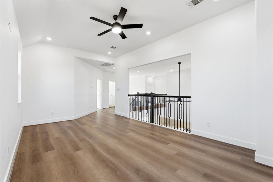 An upstairs family room offers flexible use as a game room, media room, or play area.