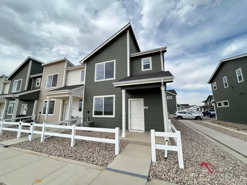 Front exterior of a new home in Liberty Draw, Evans, CO, highlighting curb appeal (Image 1). Front exterior of a new home in Liberty Draw, Evans, CO, highlighting curb appeal (Image 1).