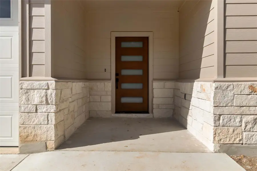 Doorway to property with stone siding