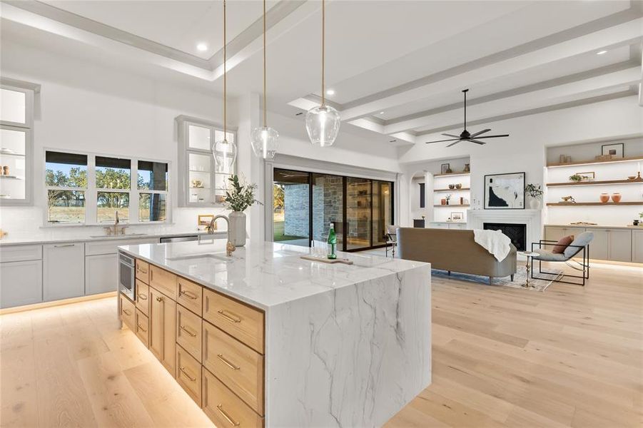 Open-concept living space with light wood-finish flooring
