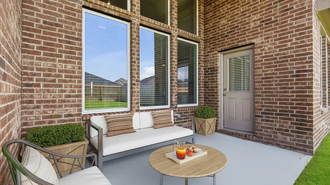 A spacious upstairs living area with plenty of natural light from windows overlooking side of the home