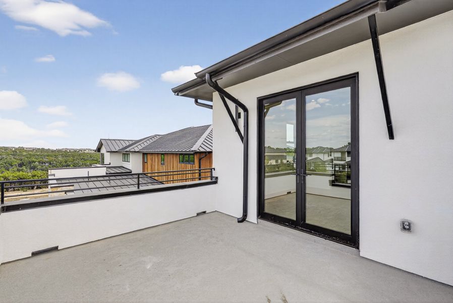 Exterior details and patio area of a home in Milky Way at River Place, Austin (Image 19).