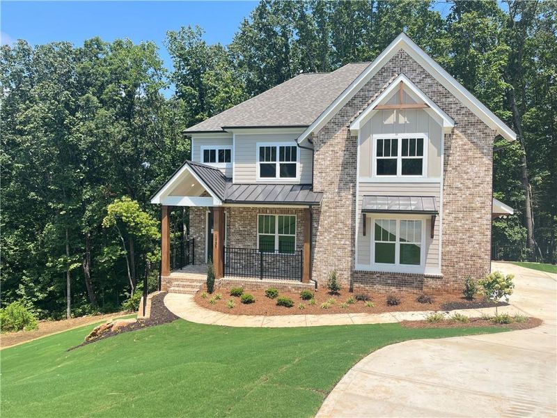 Front exterior of a new home in Liberty Springs, Woodstock, GA, highlighting curb appeal (Image 1). Front exterior of a new home in Liberty Springs, Woodstock, GA, highlighting curb appeal (Image 1).