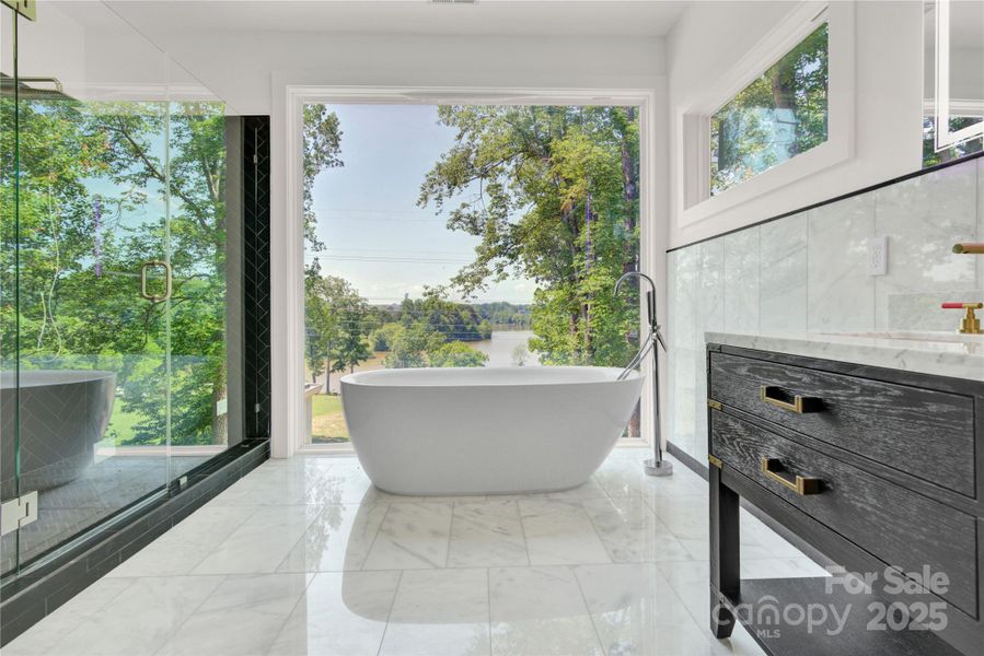 Luxurious primary bath with lake views Luxurious primary bath with lake views