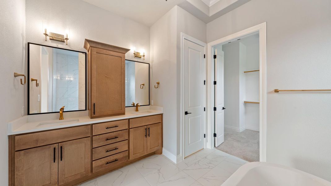 Full bath featuring a freestanding bath and light marble finish flooring