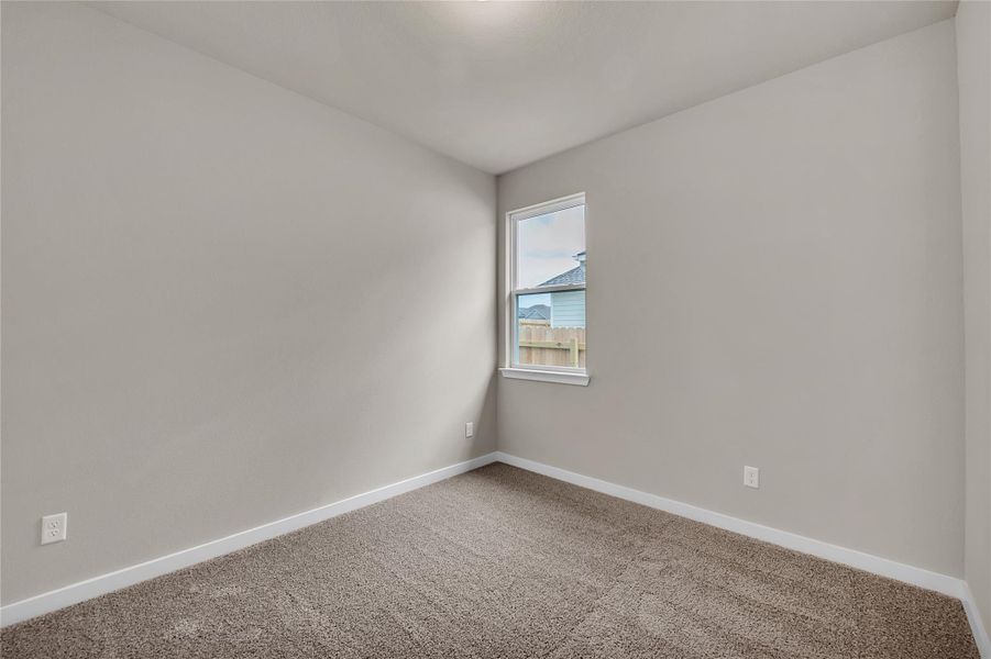 Unfurnished room with baseboards and carpet flooring
