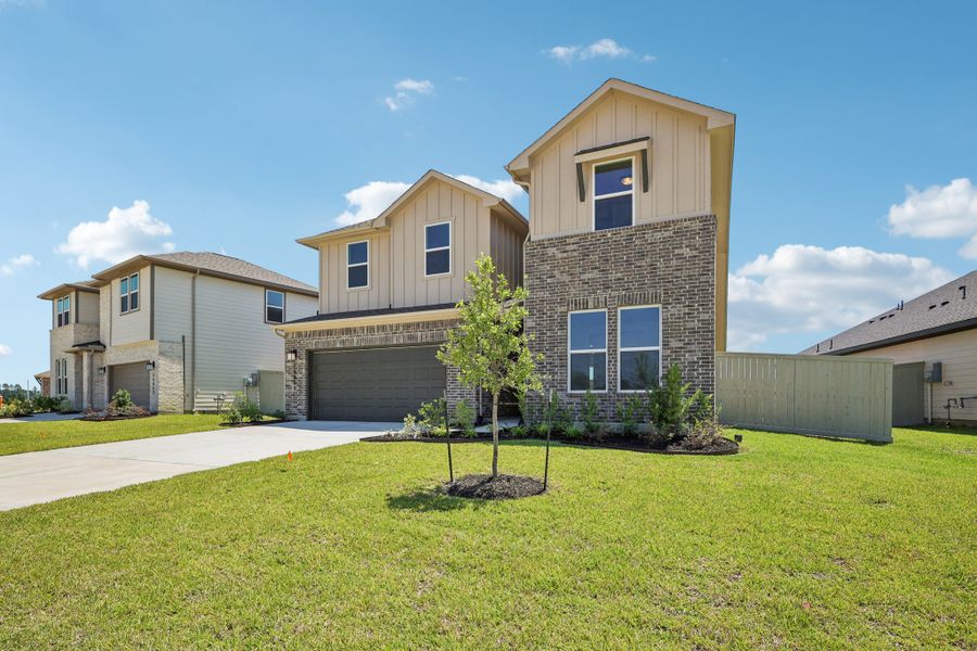 Front exterior of a new home in The Canopies, Splendora, TX, highlighting curb appeal (Image 2).