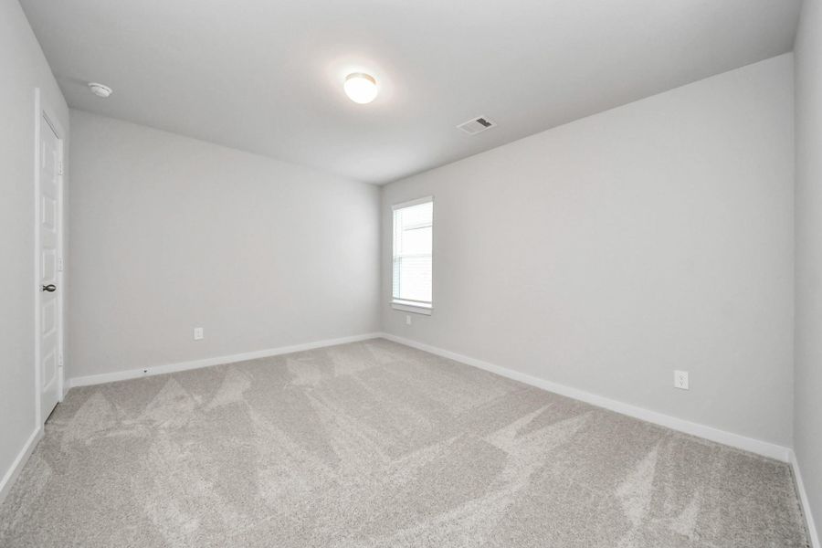 Secondary bedroom features plush carpeting, large windows that let in plenty of natural light, bright paint, and spacious closets. Secondary bedroom features plush carpeting, large windows that let in plenty of natural light, bright paint, and spacious closets.