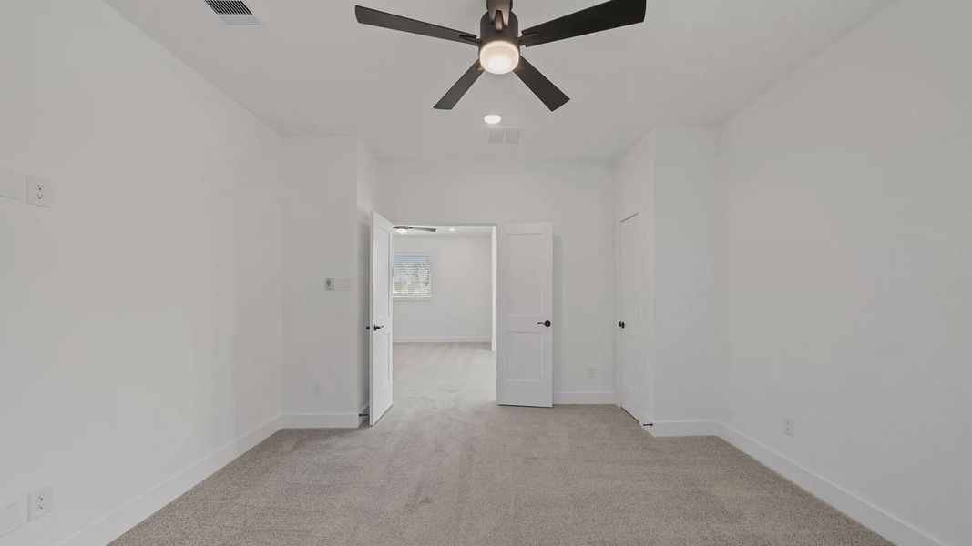 Representative unfurnished interior of a home built from the Waterloo by Chesmar Homes in Sofi Lakes, Katy (Image 36).
