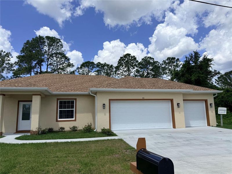 Front exterior of a new home in , Palm Coast, FL, highlighting curb appeal (Image 27).