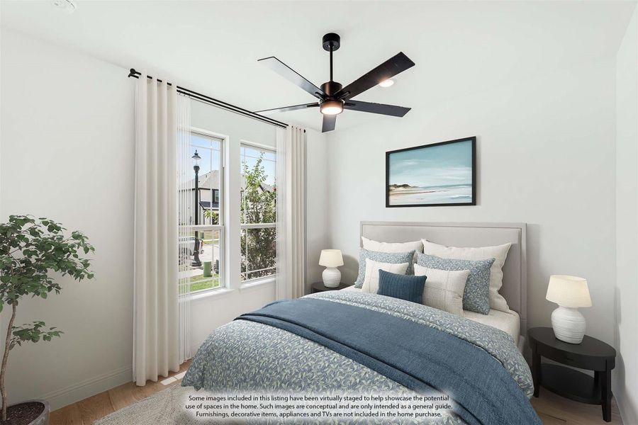 Bedroom with upholstered bed, blue bedding, ceiling fan, and two windows with white curtains