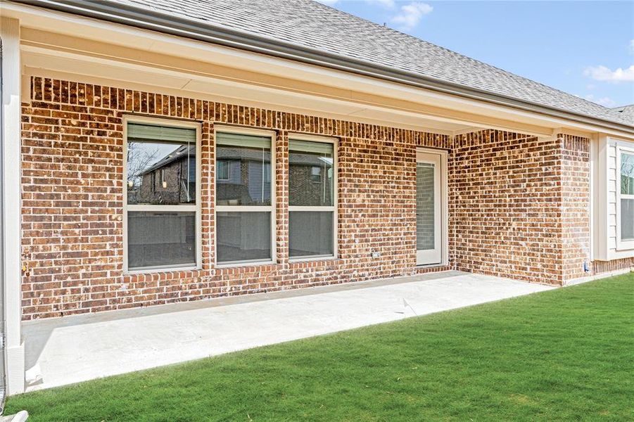 Exterior details and patio area of a home in West Crossing, Anna (Image 22).