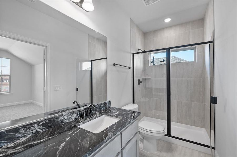 Bathroom featuring vanity, a shower stall, and recessed lighting