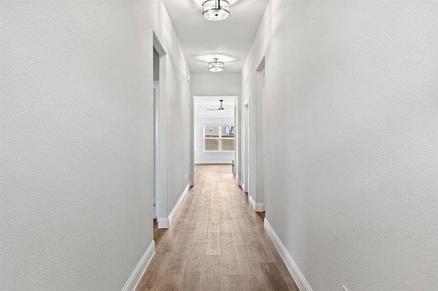 Hall featuring baseboards and light wood-style flooring
