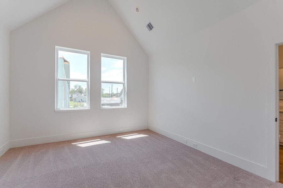 This is a bright, empty room with a vaulted ceiling and two large windows, allowing for plenty of natural light. The neutral walls and carpet provide a clean, versatile space.Photo Disclaimer: Photos are representative of the community and may depict a similar floor plan, model home, or previously completed residence. This is a bright, empty room with a vaulted ceiling and two large windows, allowing for plenty of natural light. The neutral walls and carpet provide a clean, versatile space.Photo Disclaimer: Photos are representative of the community and may depict a similar floor plan, model home, or previously completed residence.