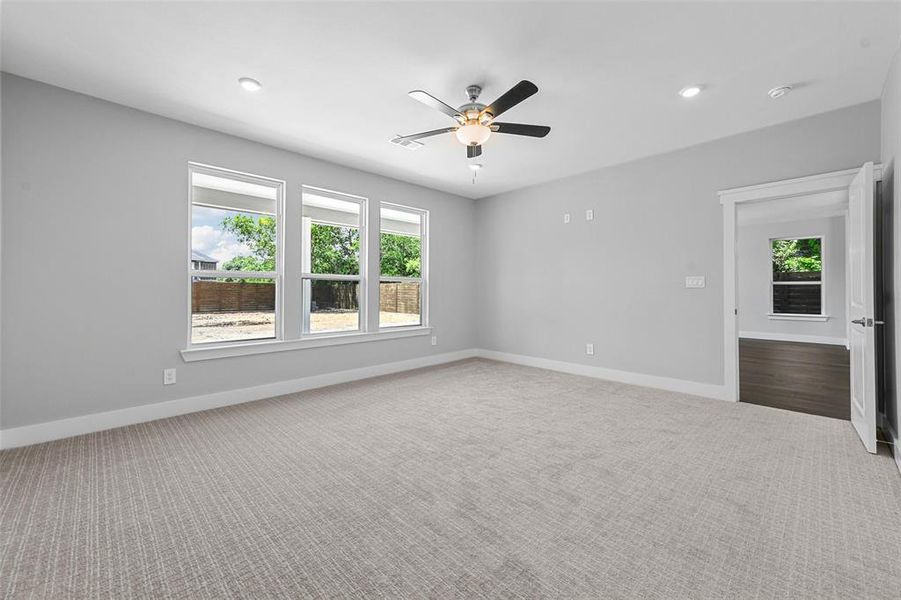 Unfurnished room with ceiling fan and carpet flooring