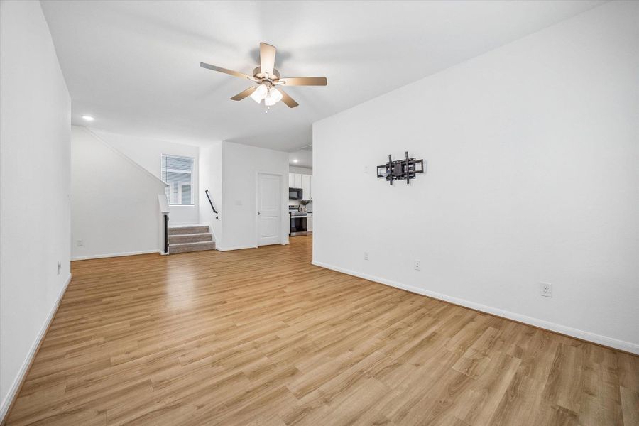 Unfurnished living room with a ceiling fan, light wood-style floors, and recessed lighting