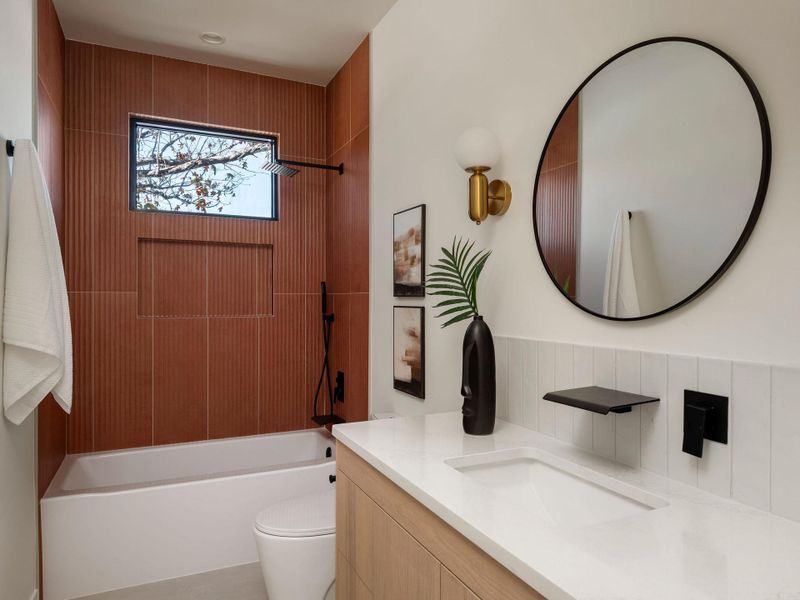 Bathroom featuring vanity and washtub / shower combination